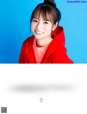 A woman in a red hoodie on the cover of a magazine.