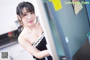 A woman in a white lingerie leaning against a mirror.