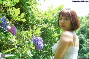 A naked asian woman posing in a blue bra and panties.