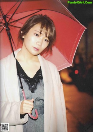 A magazine spread with a picture of a woman in a white jacket.