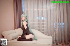 A woman sitting on top of a white couch.