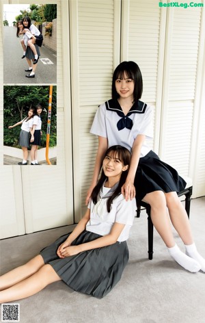 Two young women in school uniforms holding hands on a street.
