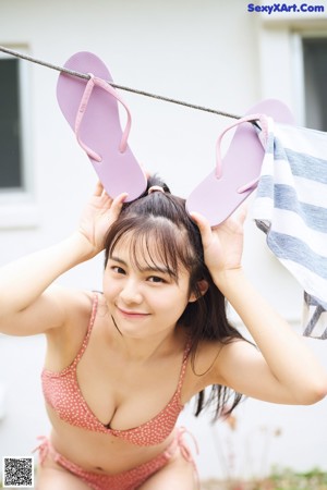 A woman in a swimming pool smiling at the camera.