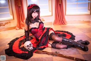 A woman in lingerie sitting on a bed with a gun.