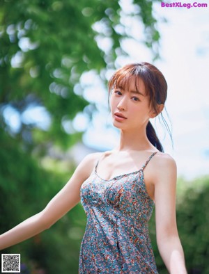 A woman in a blue and white striped shirt and shorts.