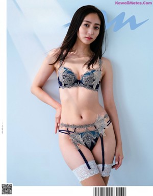 A woman in a white shirt is posing for a magazine.