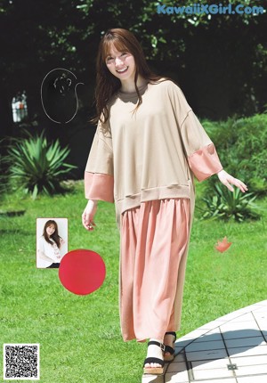 A woman with long brown hair is posing for a magazine cover.
