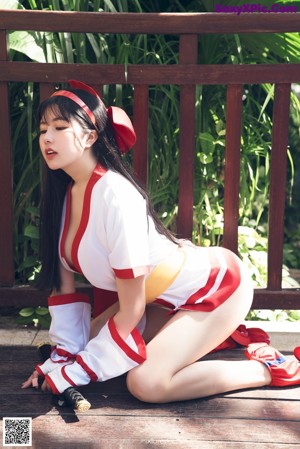 A woman in a red and white outfit is standing in a pool.