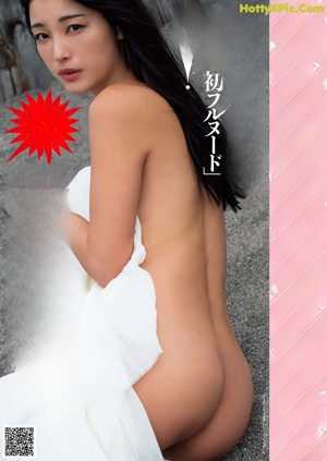 A naked woman sitting on a couch next to a window.