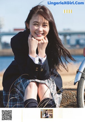 A woman in a yellow dress is posing for a magazine.
